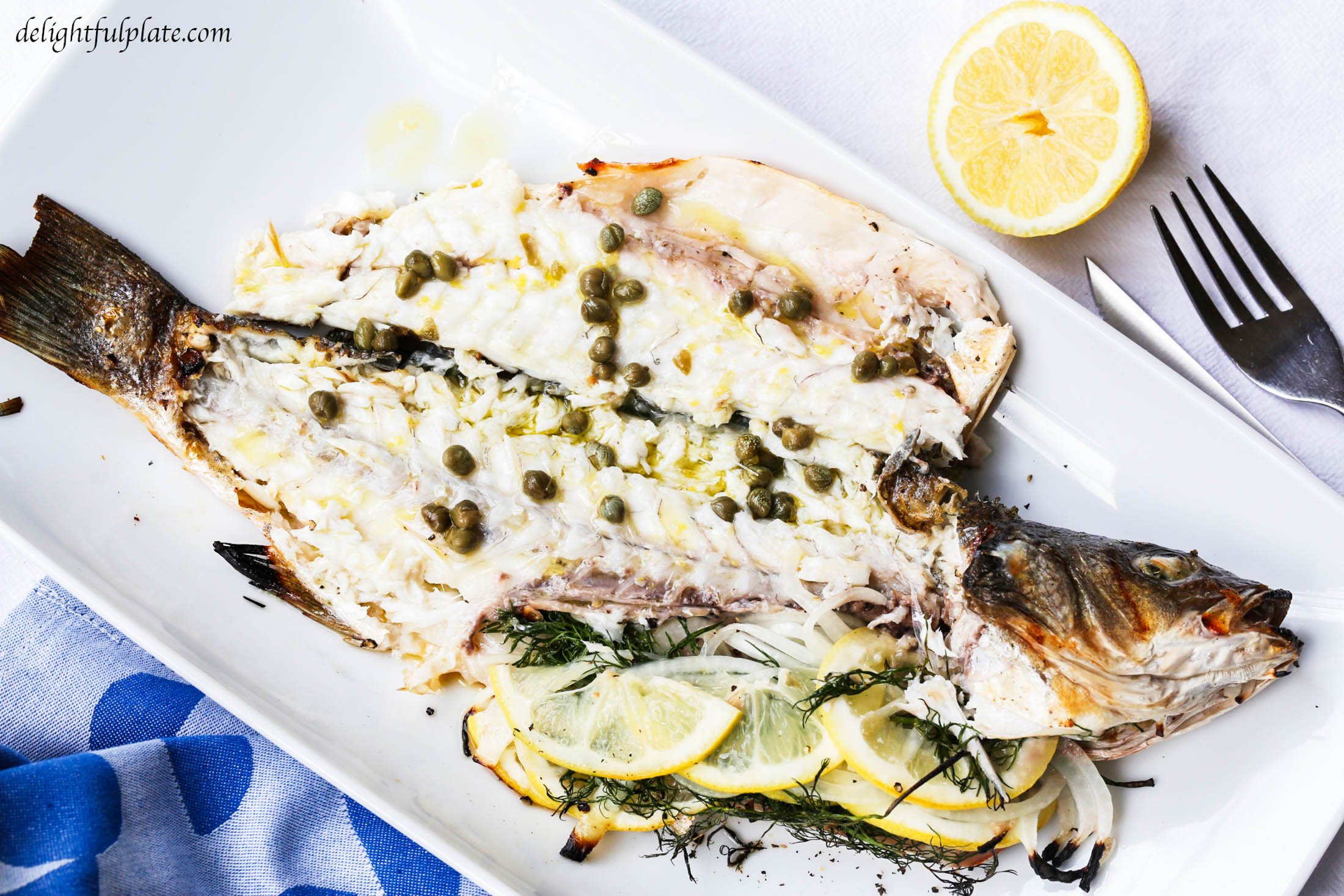 Grilled whole branzino with lemon caper sauce