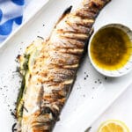 Grilled whole branzino with lemon caper sauce. Find all the tips you need for grilling and serving whole fish.