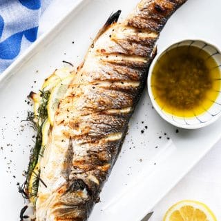 Grilled whole branzino with lemon caper sauce. Find all the tips you need for grilling and serving whole fish.