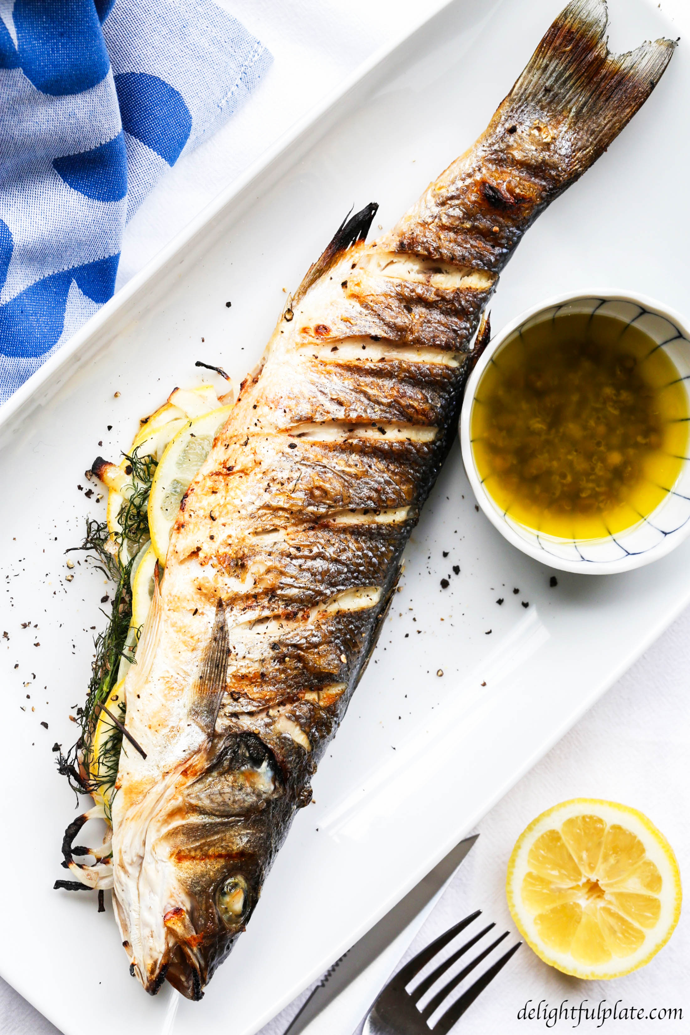 Grilled whole branzino with lemon caper sauce. Find all the tips you need for grilling and serving whole fish.