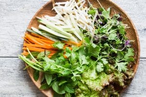 Fresh veggies and herbs for Vietnamese Beef Noodle Salad: lettuce, carrot, cucumber and bean sprouts.