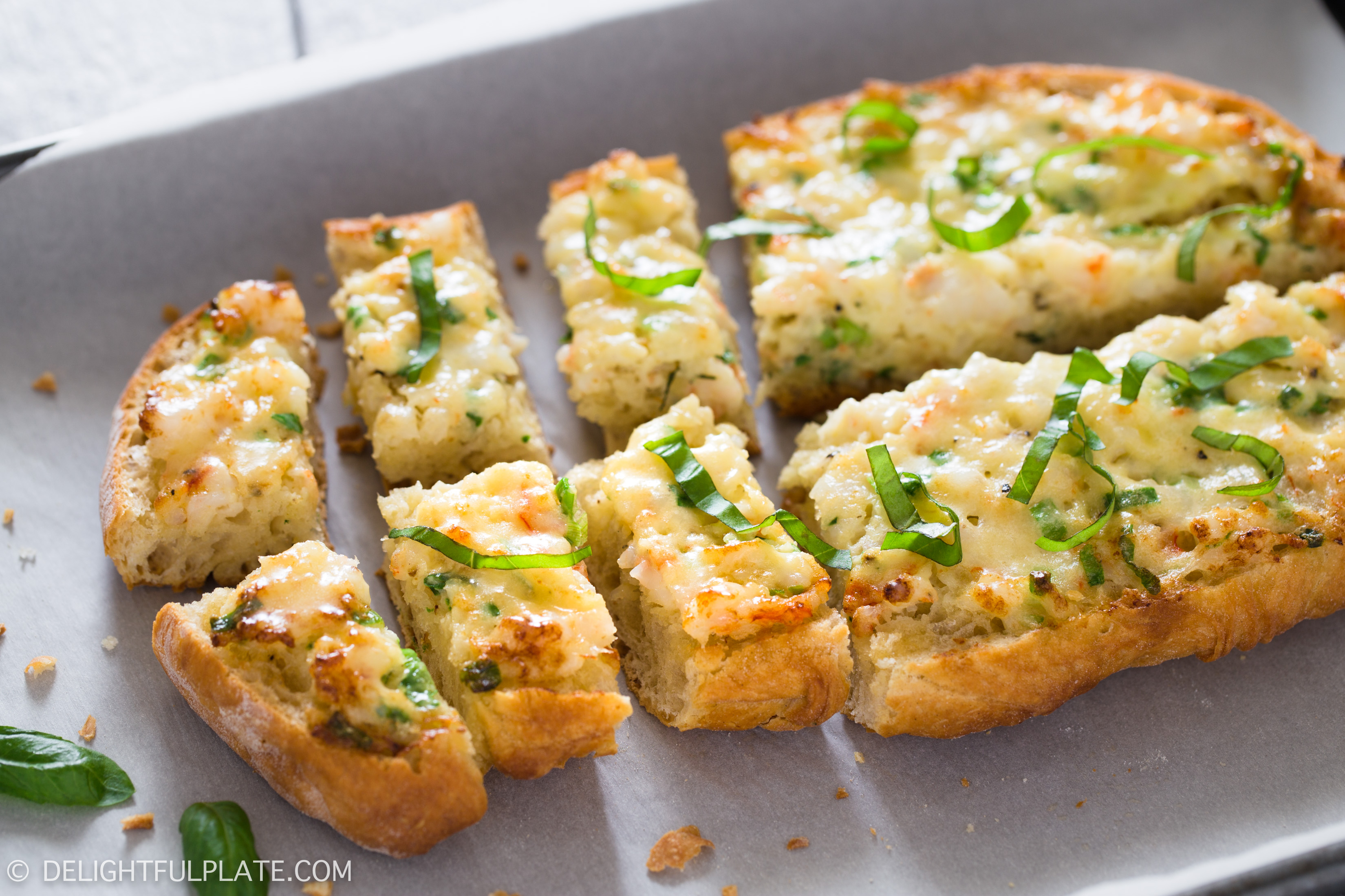This baked shrimp toast features flavorful shrimp mixture on top of crispy bread. Sprinkle some fresh basil and serve as an appetizer for parties, holidays or any meals.