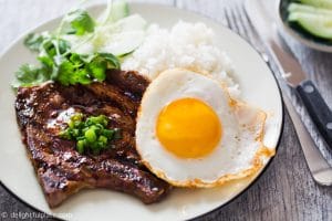 Vietnamese grilled lemongrass pork chops, served with rice and a fried egg. These pork chops are flavorful and easy to make at home.