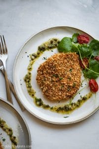 This baked pork schnitzel is crispy on the outside and juicy on the inside. It takes only 30 minutes to make and is healthier than deep-frying. Serve it with caper garlic butter sauce.