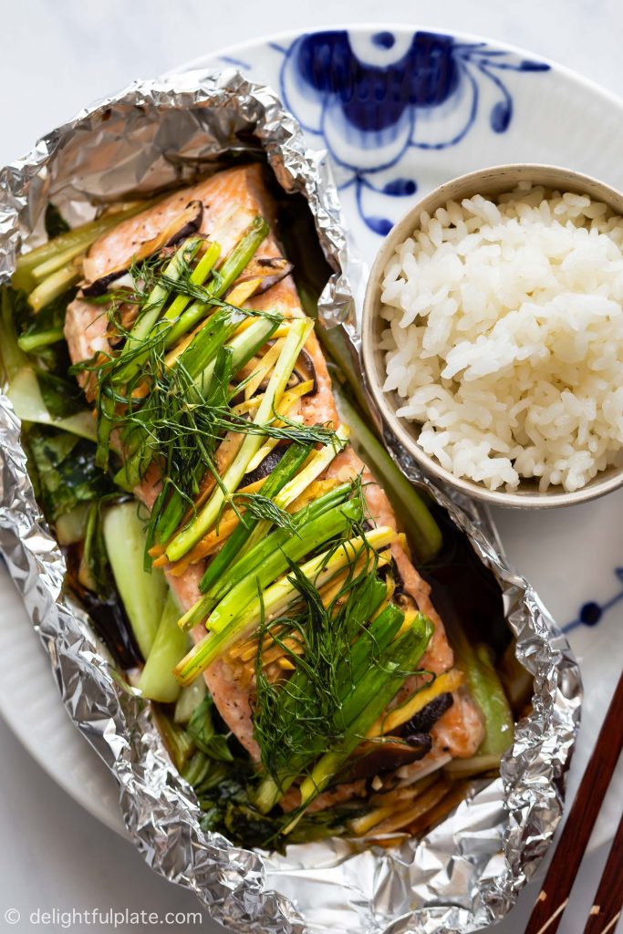 This Asian Ginger Salmon in Foil is a healthy and delicious meal packed with juicy salmon, baby bok choy and herbs. Serve with steamed rice for a quick and easy weeknight dinner.