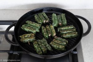 Grilling Vietnamese beef in wild betel leaves (bo cuon la lot)