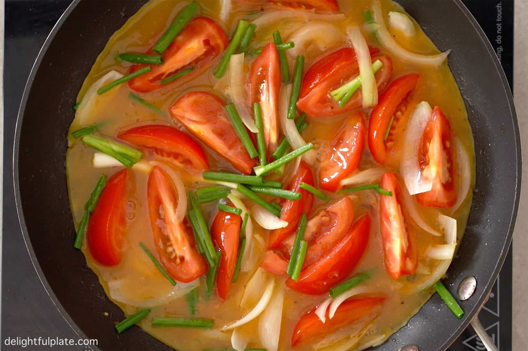 pouring beaten egg into the pan