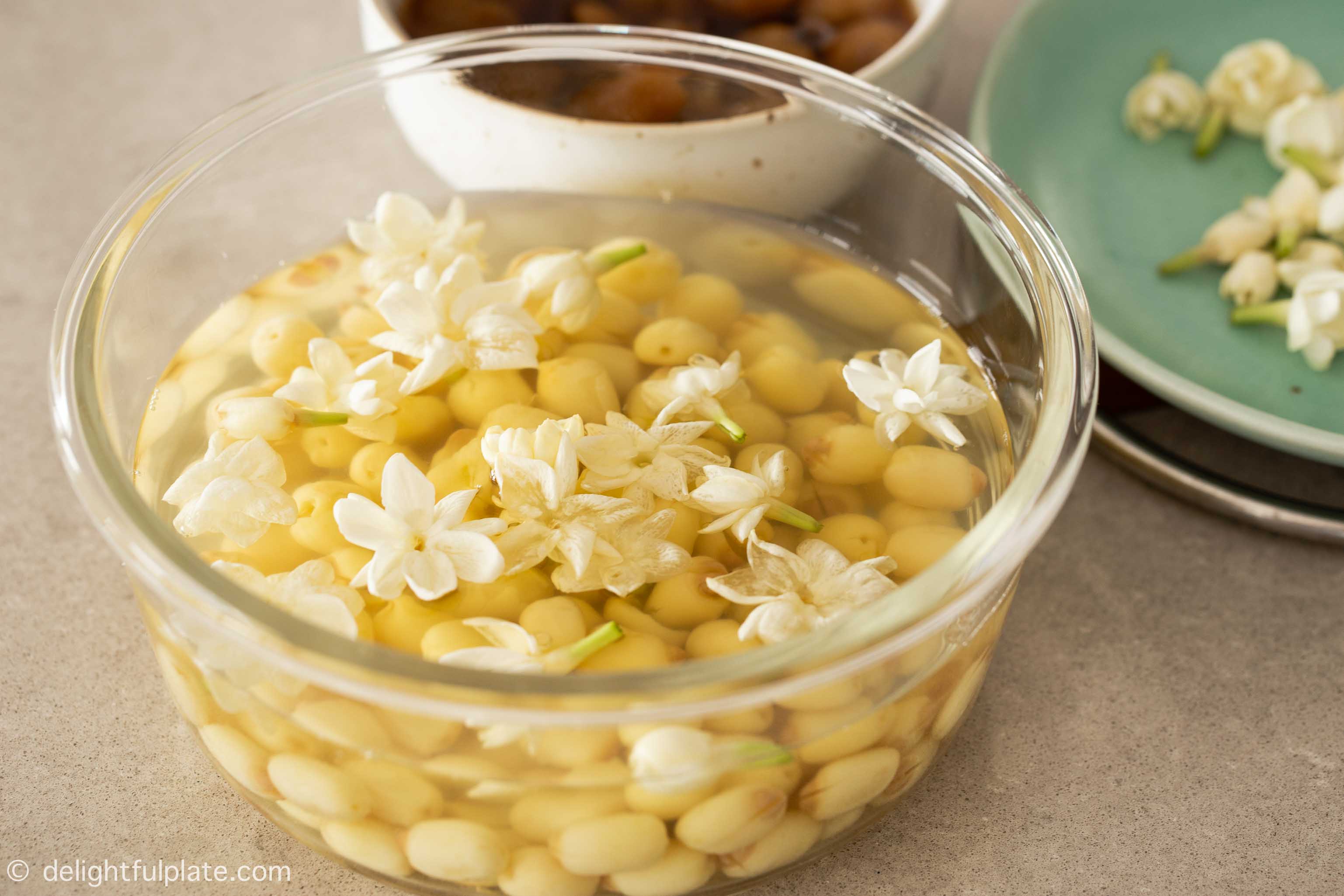 a container with lotus seed soup infused with jasmine flowers fragrance