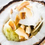 a scoop of Ince cream on top of sticky rice, served with toasted coconut flakes
