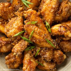 chicken wings coated with lemongrass sauce on a plate