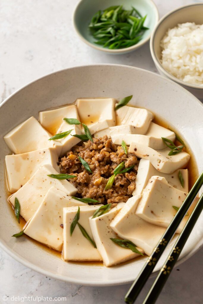 a plate of steamed tofu with ground pork