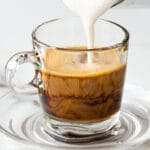 pouring milk into ginger coffee