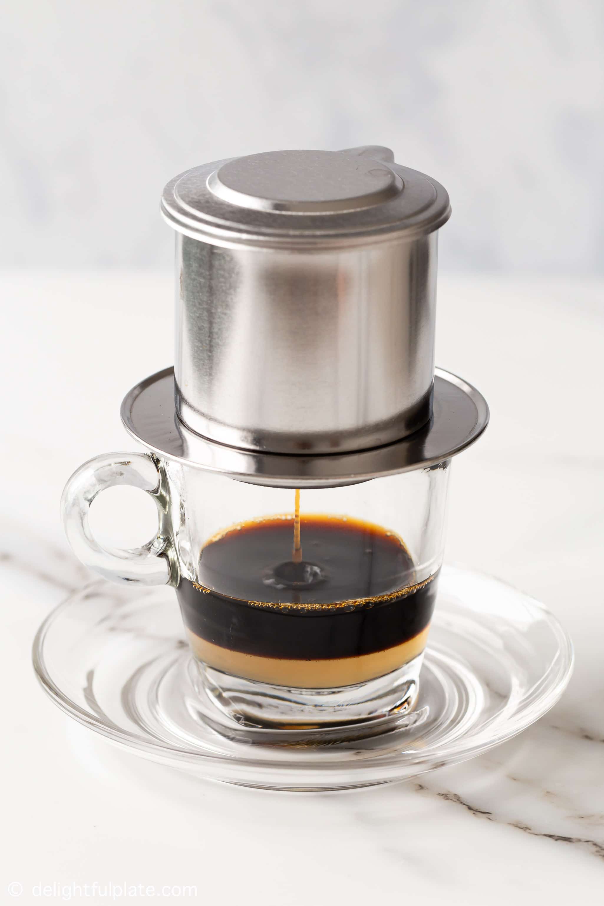 brewing Vietnamese coffee into the serving glass