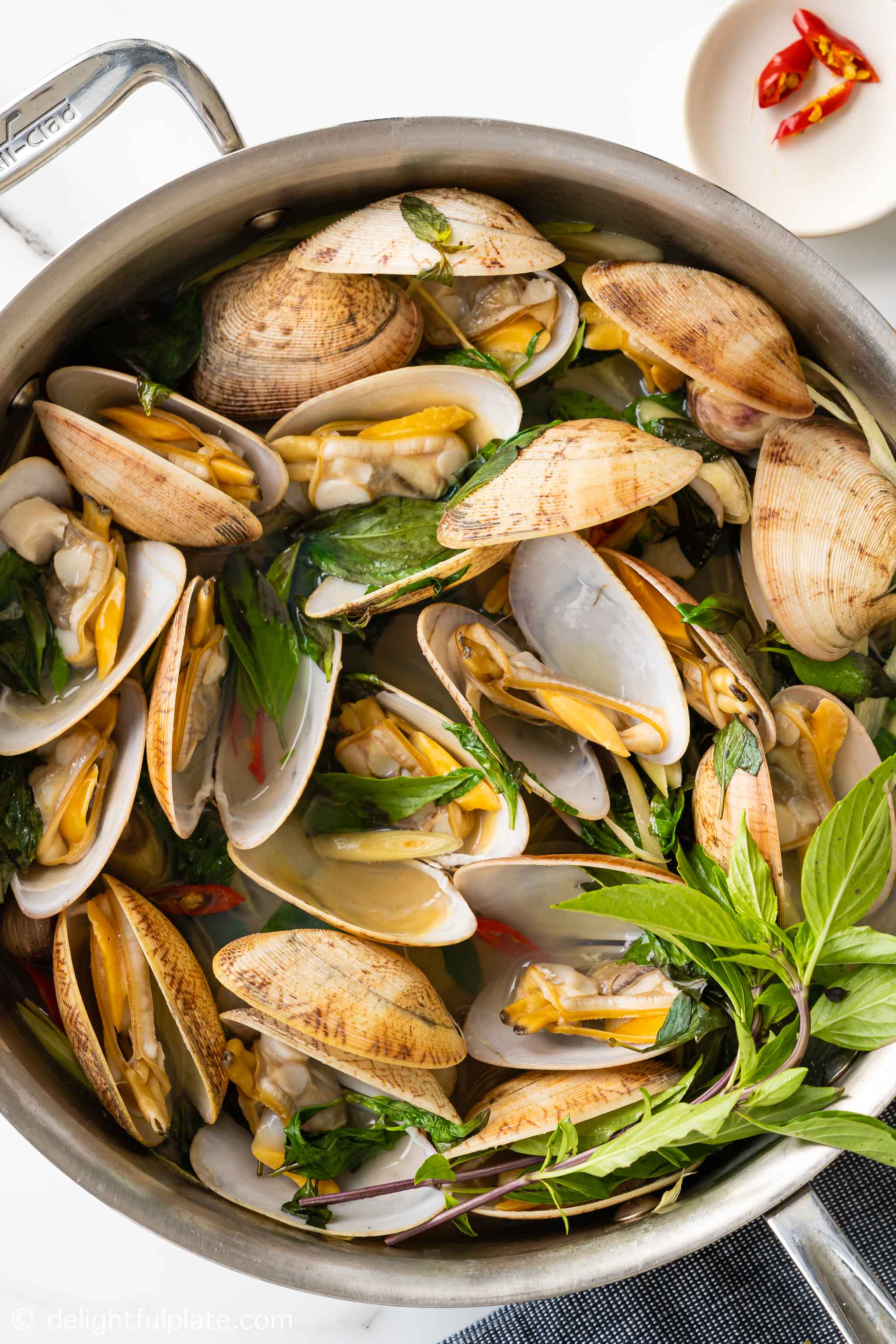 a skillet of steamed clams with Thai basil and lemongrass