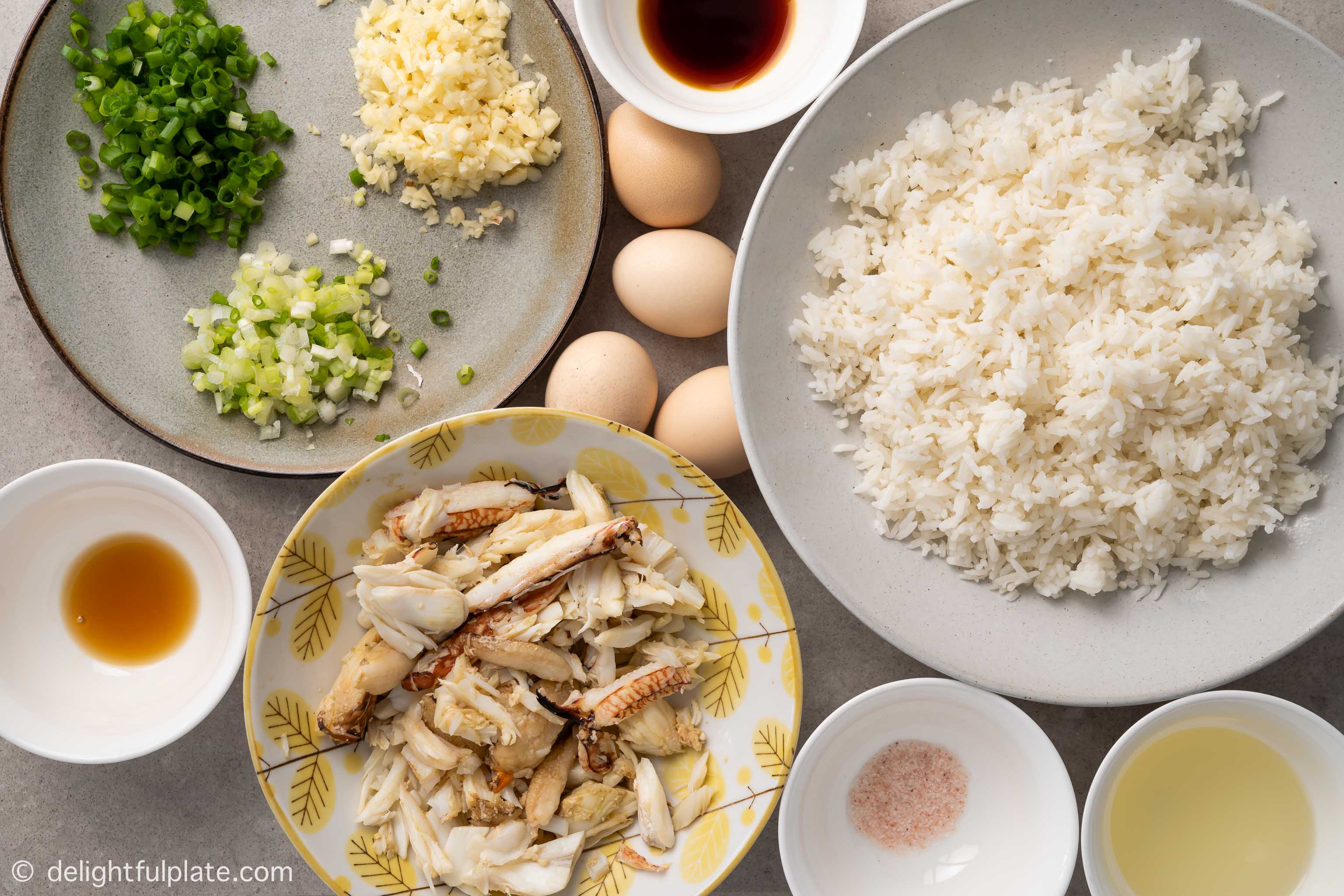 plates with ingredients for crab fried rice