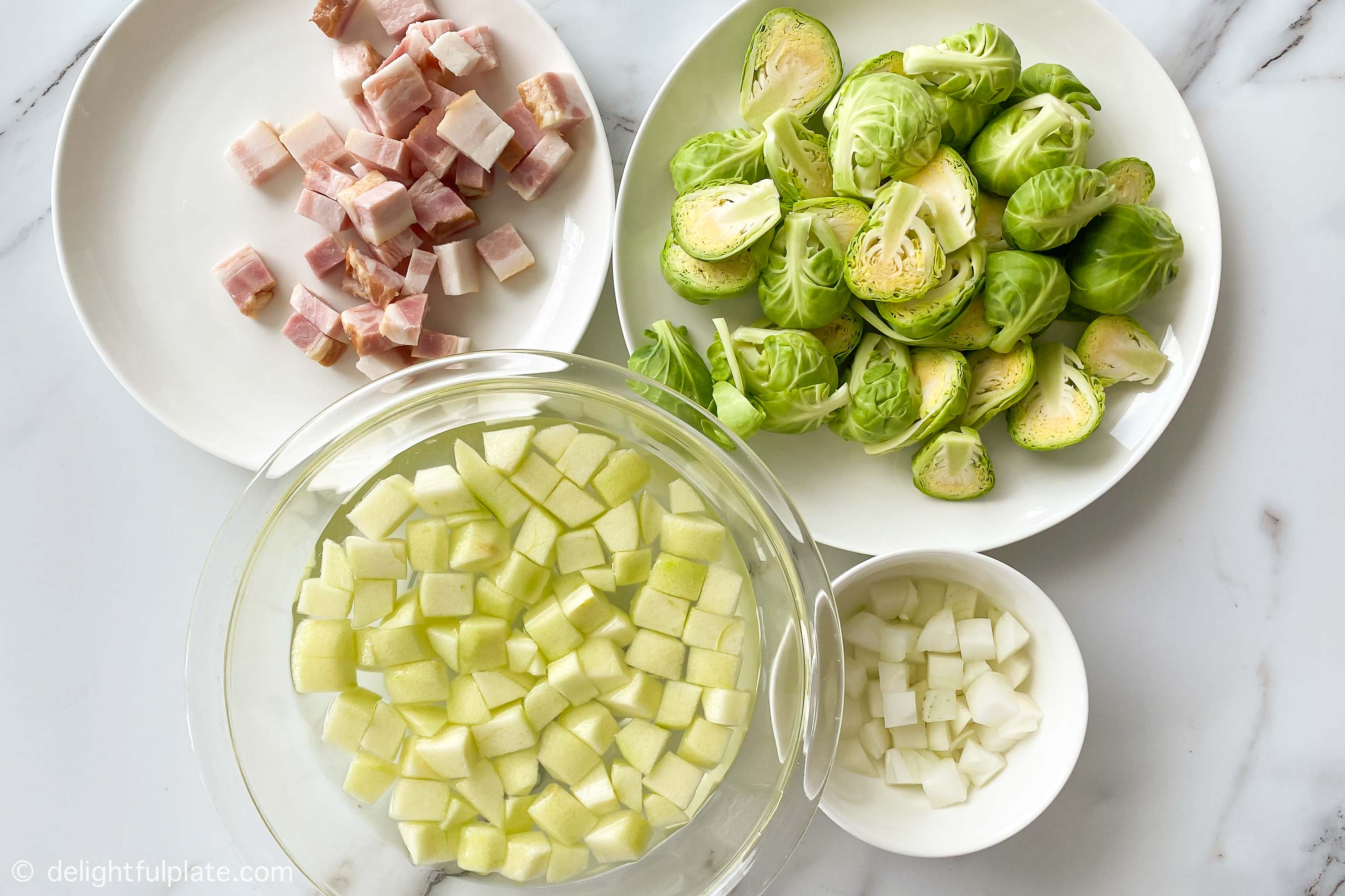 plates containing main ingredients for this sautéed Brussels sprouts recipe