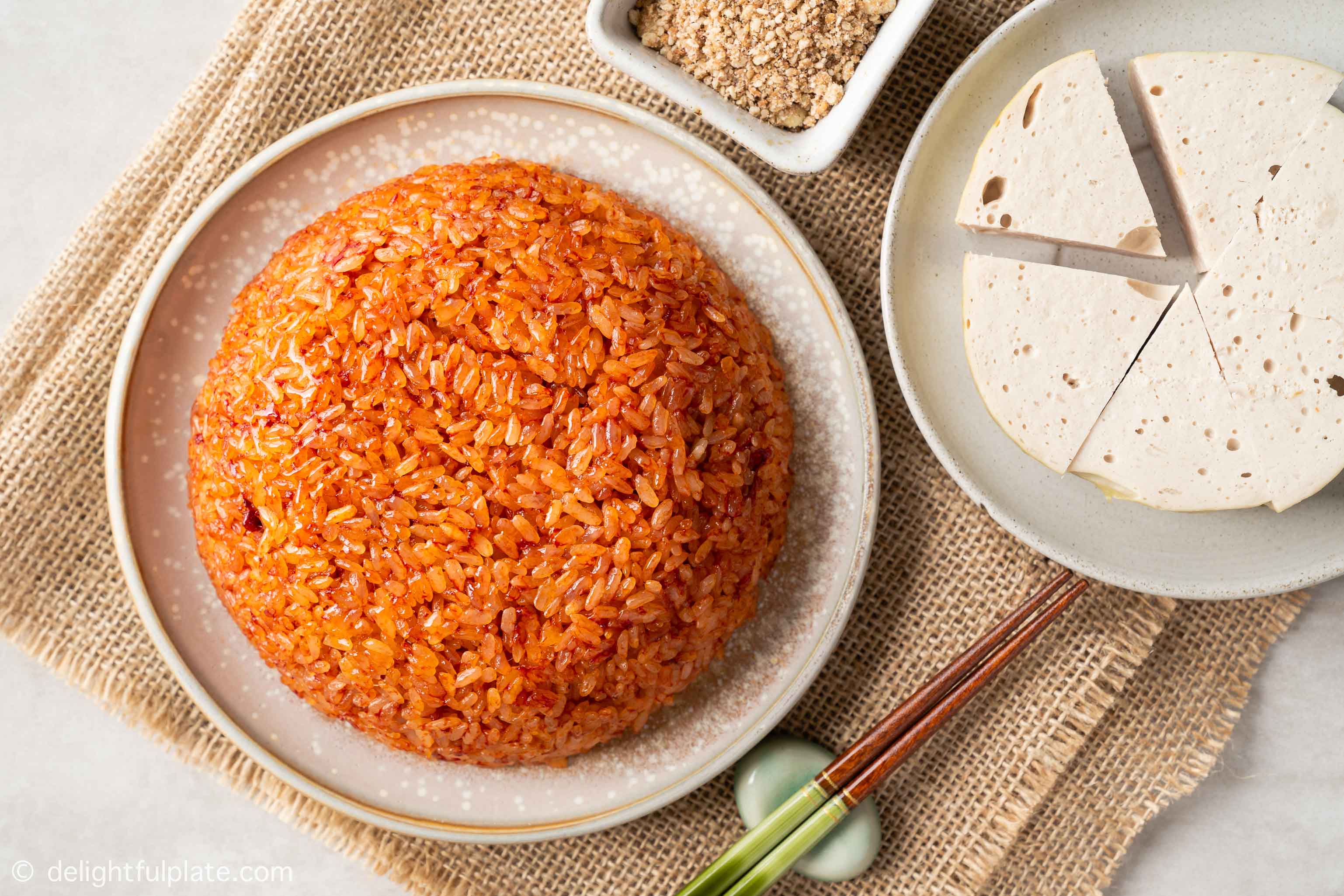 a plate of Vietnamese red sticky rice, served with Vietnamese ham