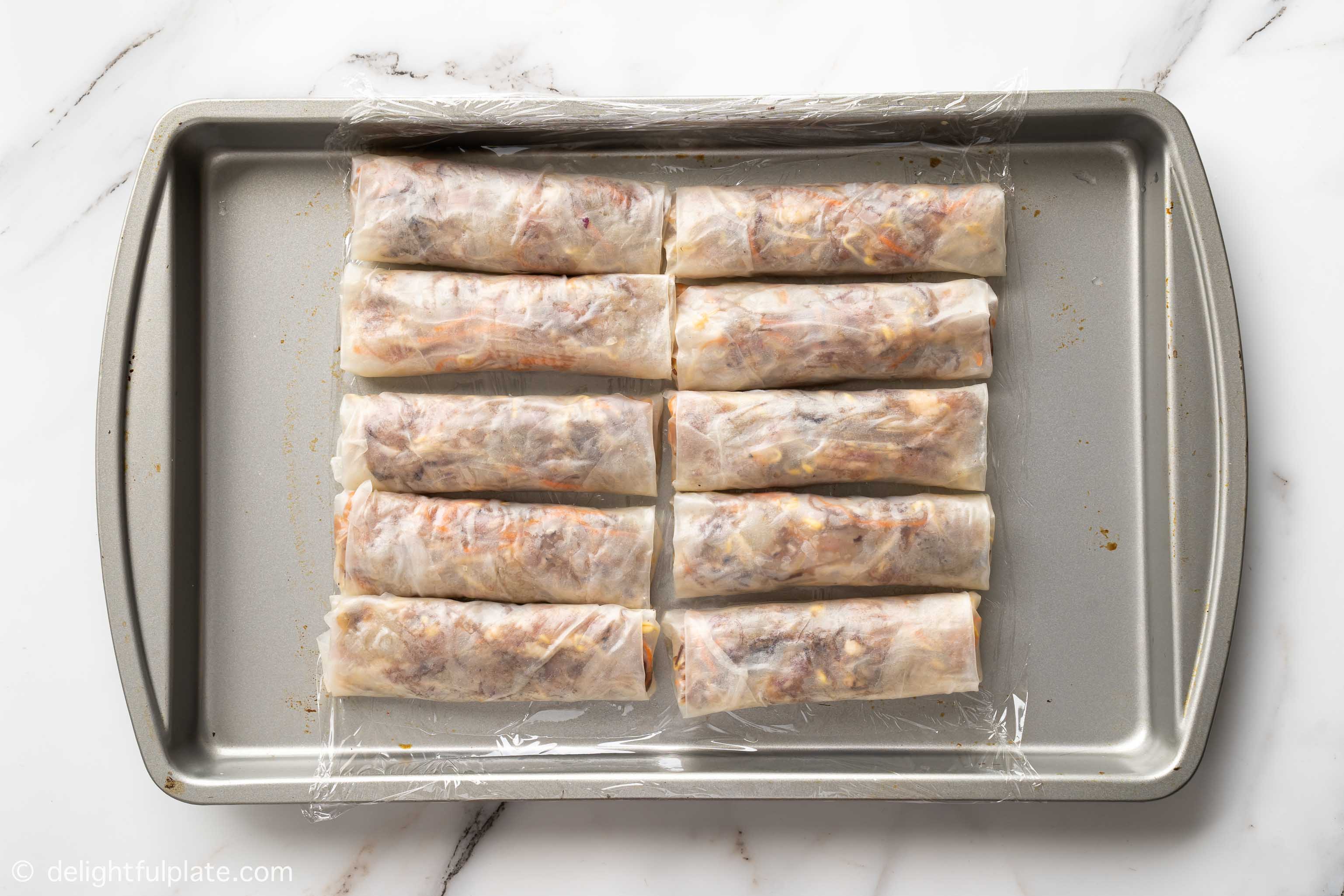 a tray of spring rolls that haven't been fried