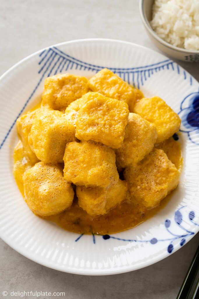 a plate of crispy silken tofu in salted egg sauce