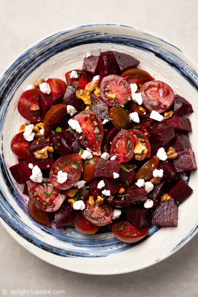 a plate of Roasted Beetroot Salad with Goat Cheese, Walnut and Cherry Tomato
