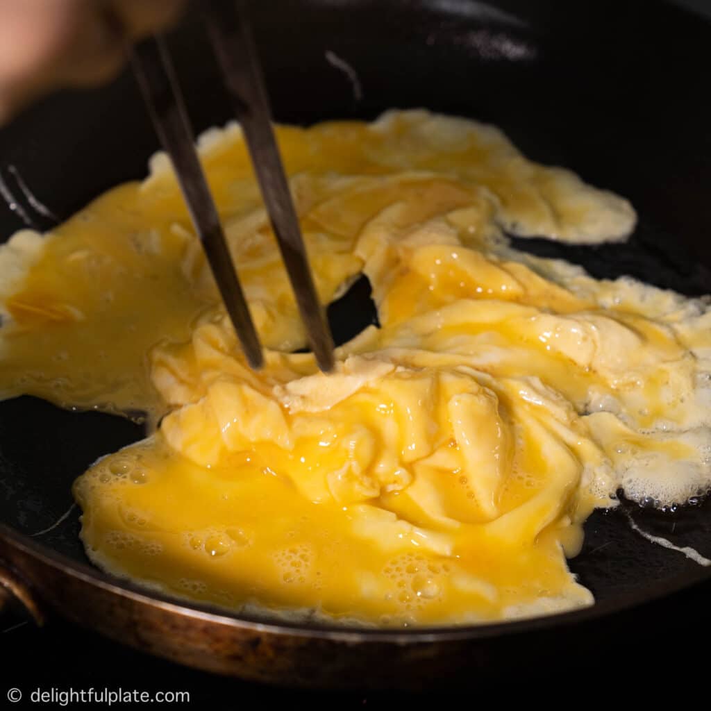 scrambling eggs in a pan