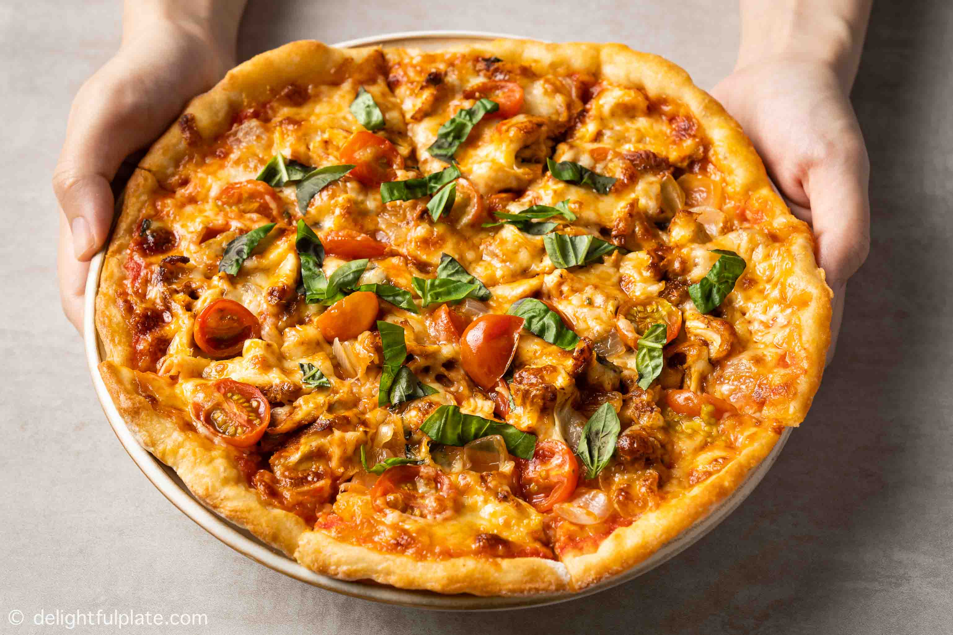 a plate of homemade chicken pizza.