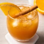 a glass of orange cinnamon tea