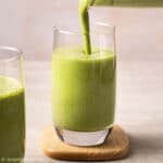 pour banana matcha smoothie into a glass