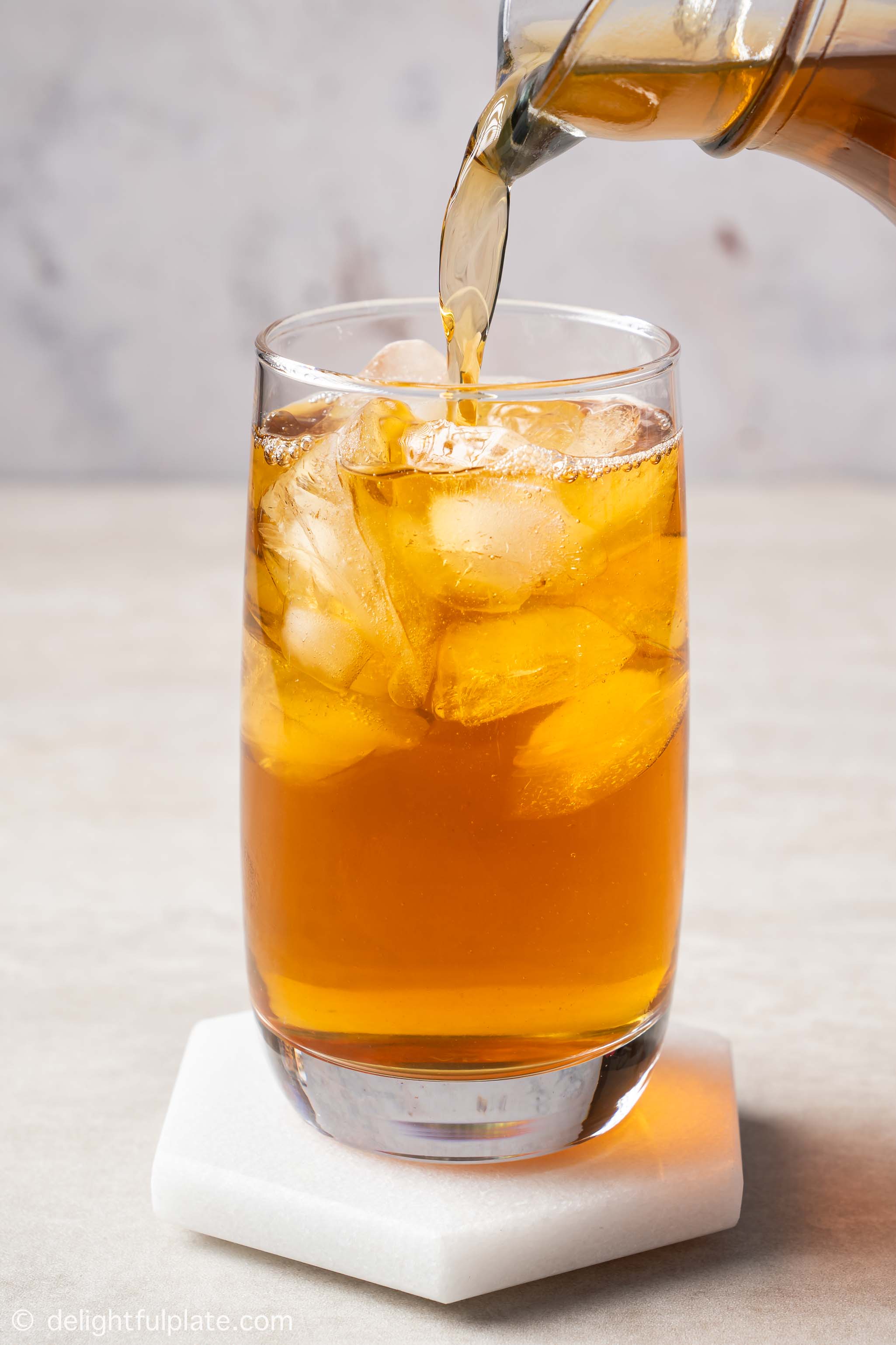 pouring winter melon tea into a glass