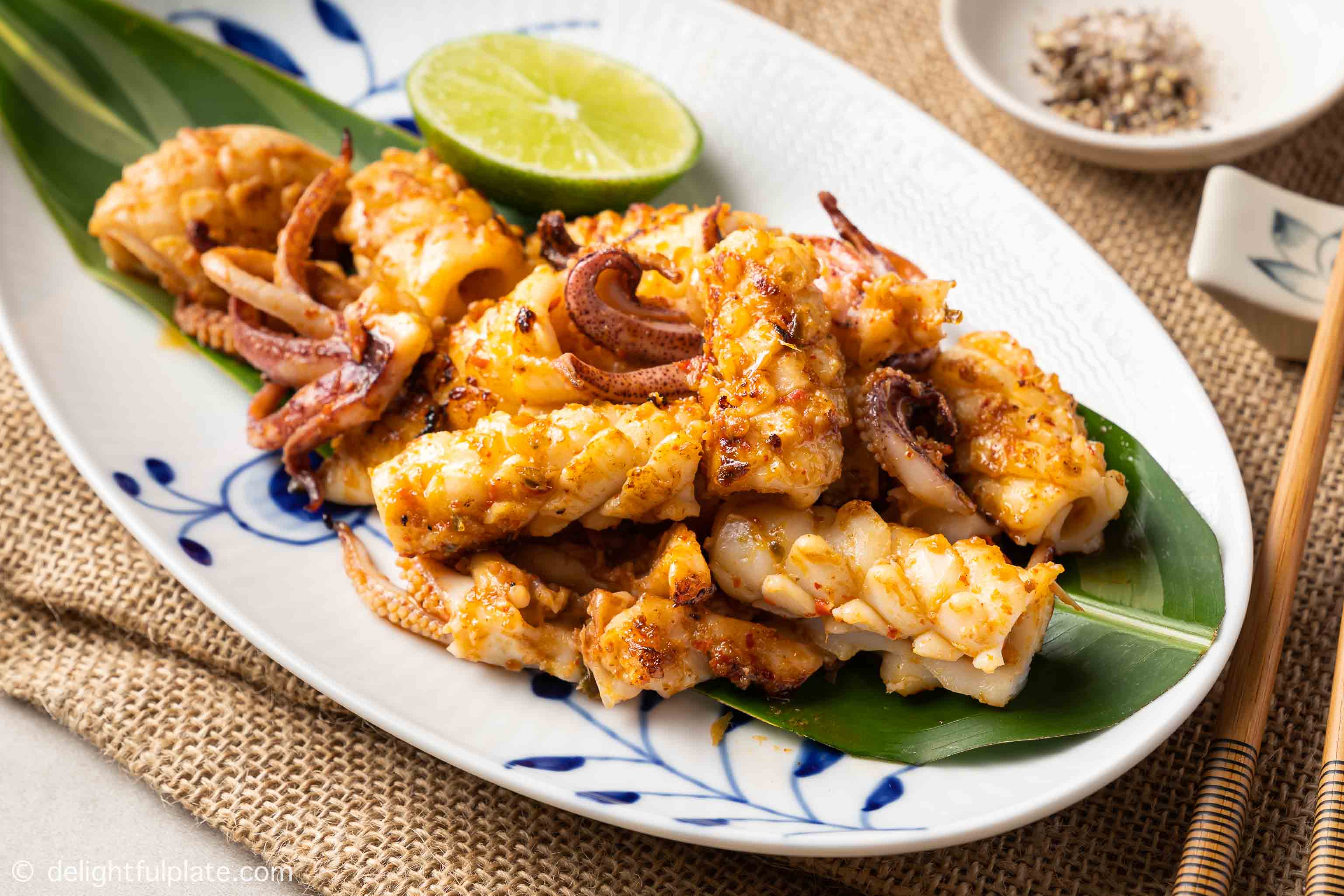 a plate of spicy grilled squid with sate sauce