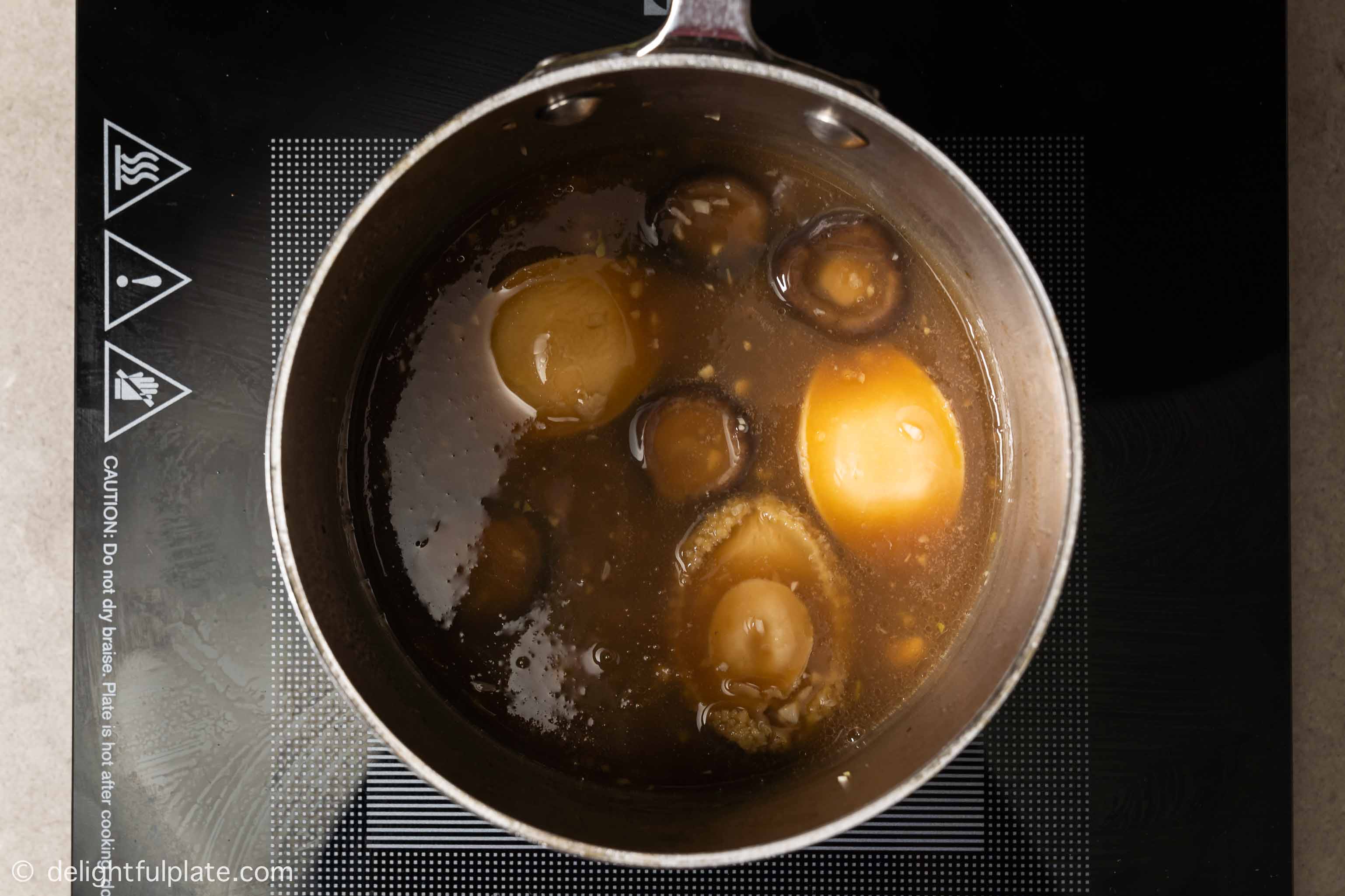 a pot containing the thickened sauce for the dish