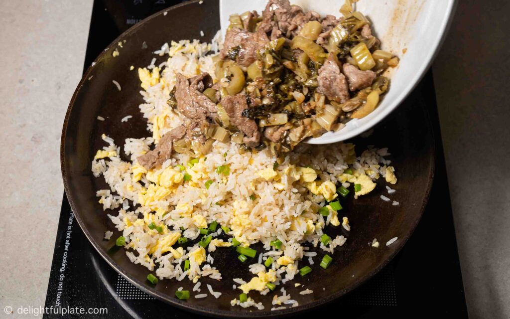 adding eggs, beef and mustard greens back to the pan