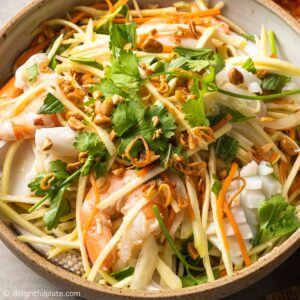 a plate of Vietnamese green mango salad with seafood.