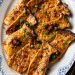 a plate of grilled king trumpet mushrooms