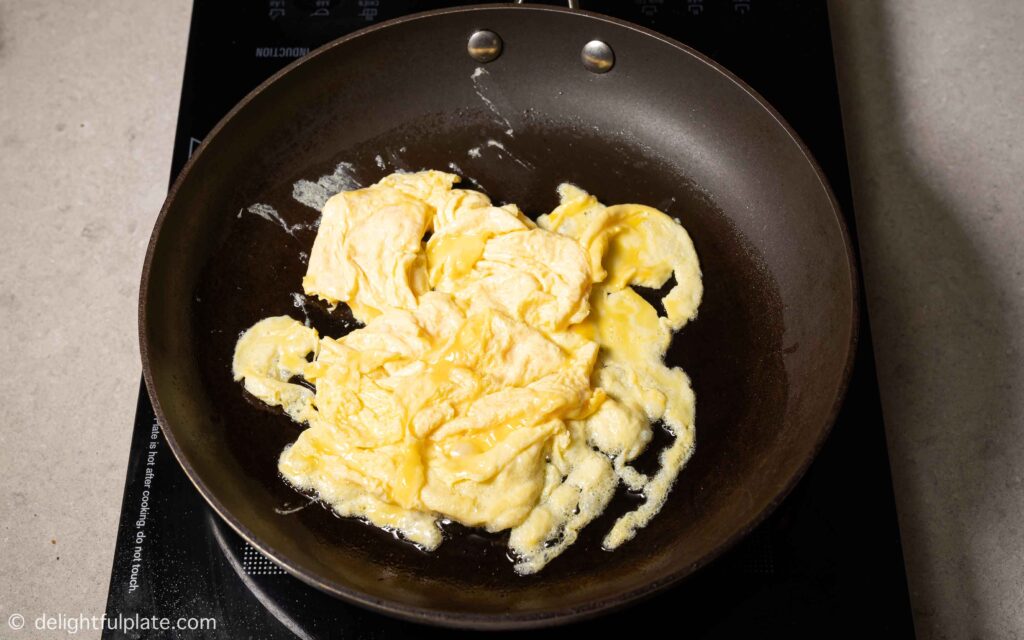 scrambling eggs in a pan