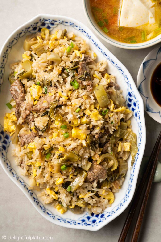 a plate of Vietnamese beef fried rice with pickled mustard greens (com rang dua bo)