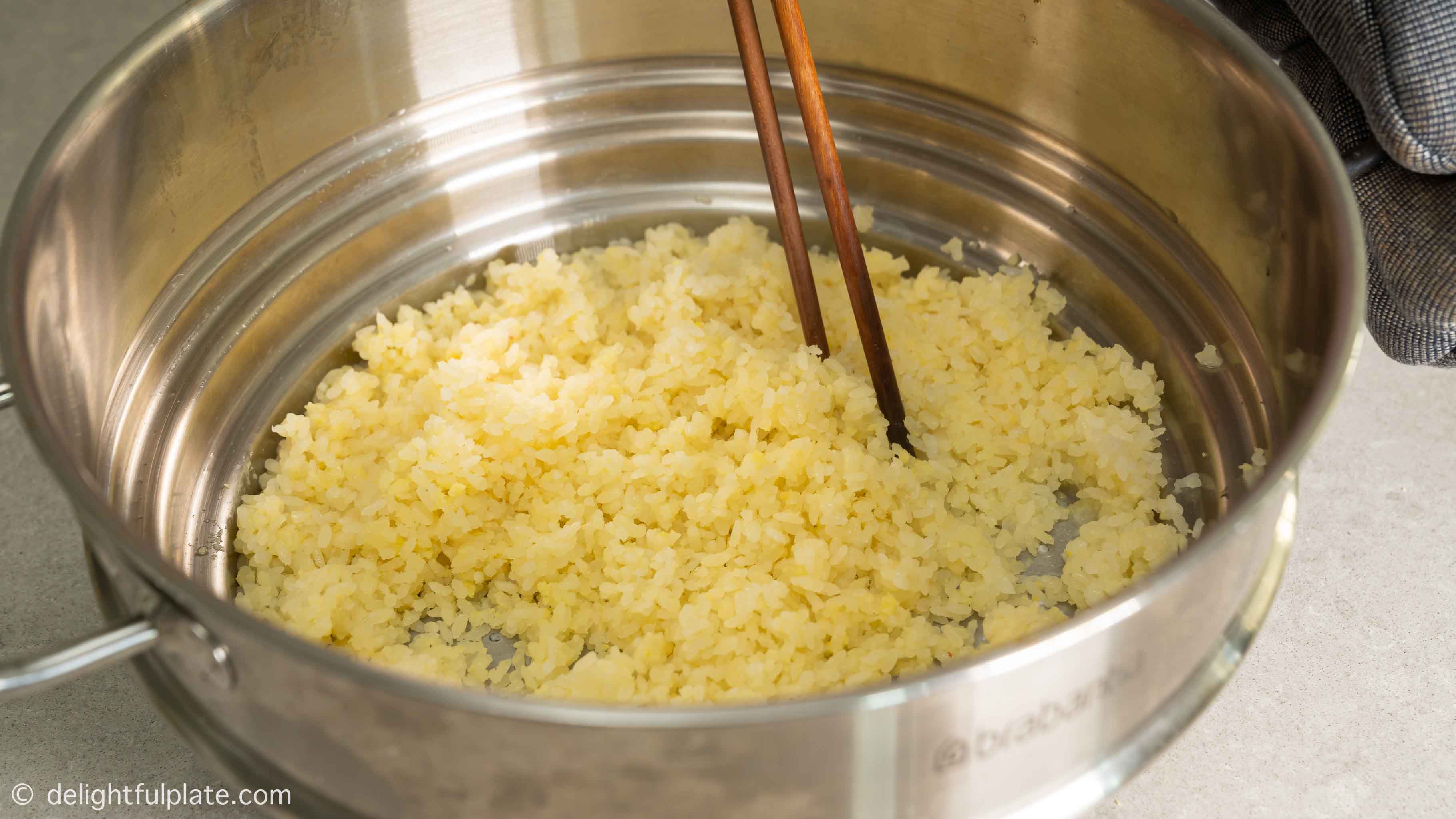 fluff the steamed rice with chopsticks