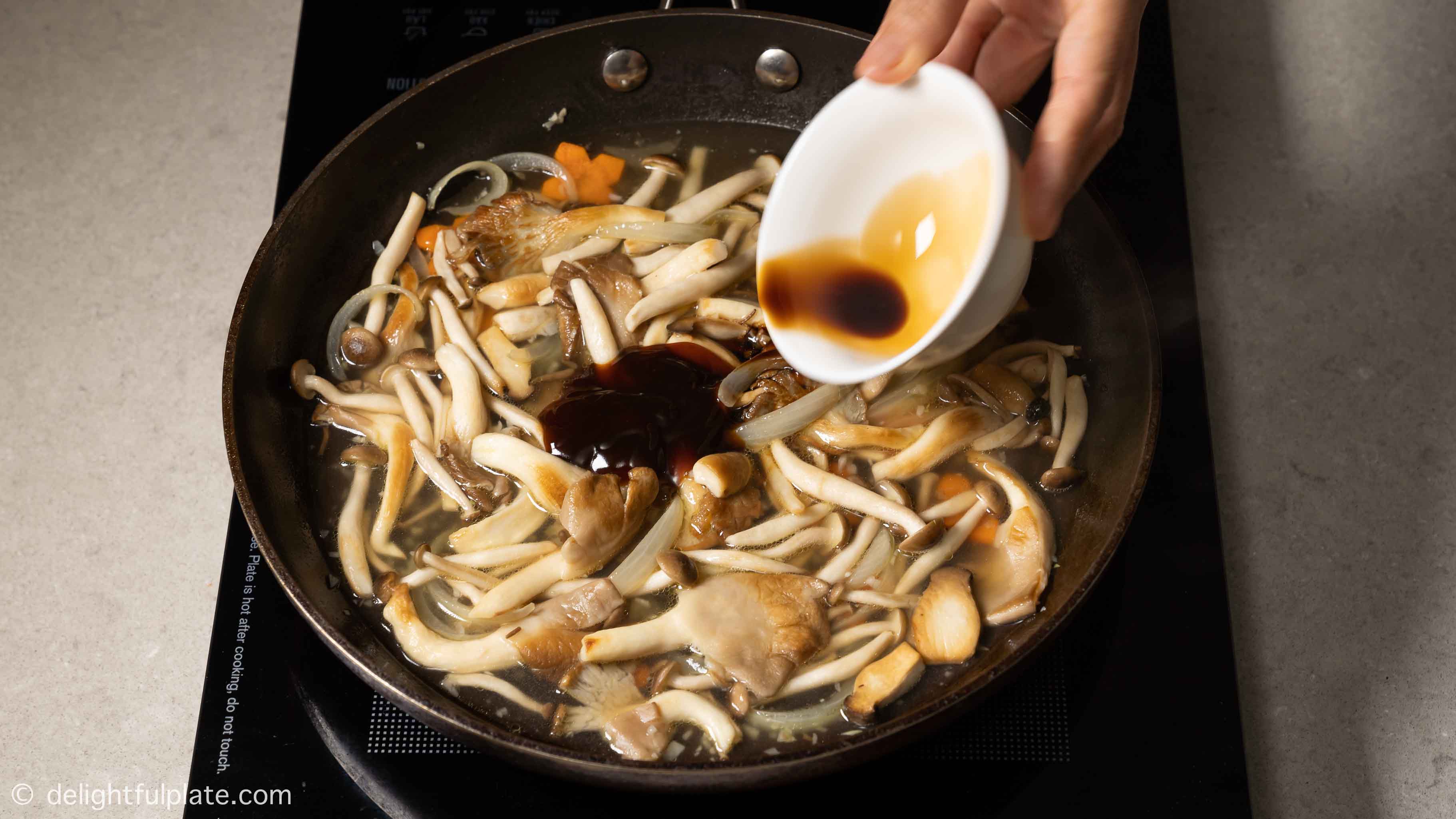 adding stock and seasonings to the sauce