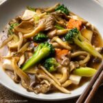 a plate of steamed tofu and mushroom, vegetables in oyster sauce