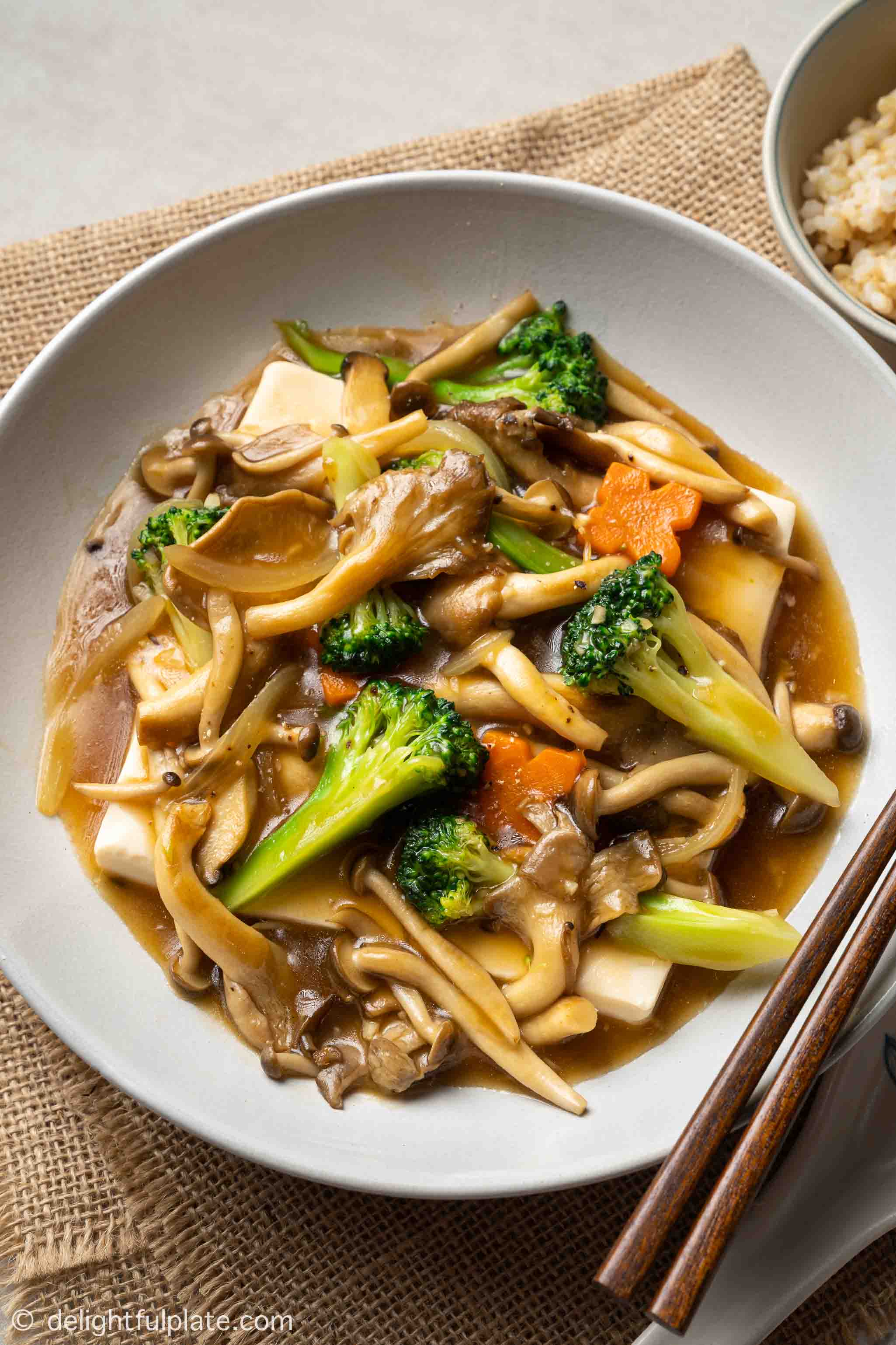a plate of steamed tofu and vegetables, mushrooms in oyster sauce