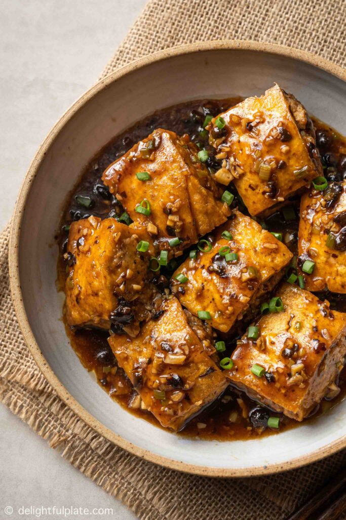 a bowl of stuffed tofu in black bean sauce