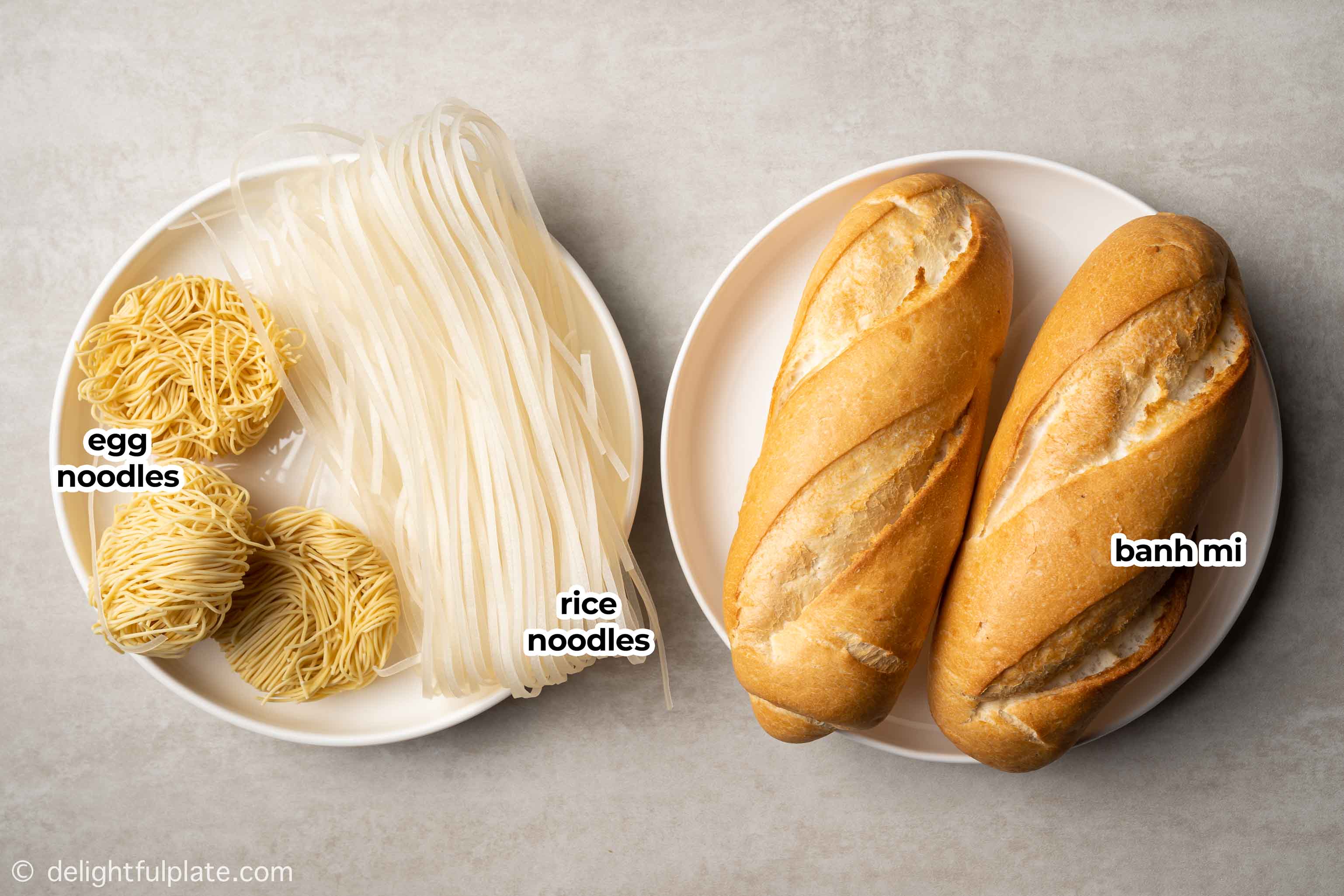 plates with dried egg noodles, rice noodles and banh mi