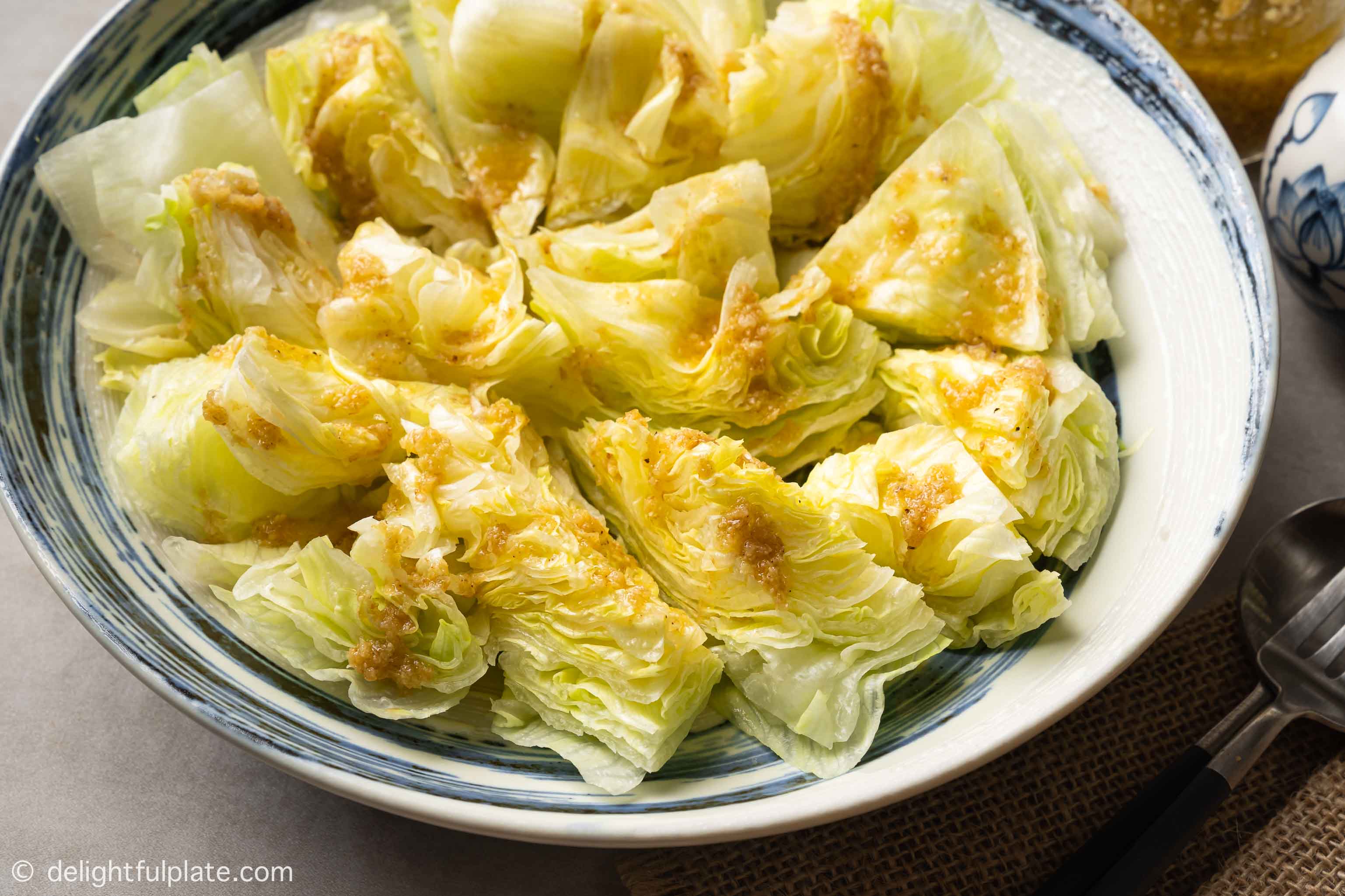 a plate of lettuce with ginger dressing