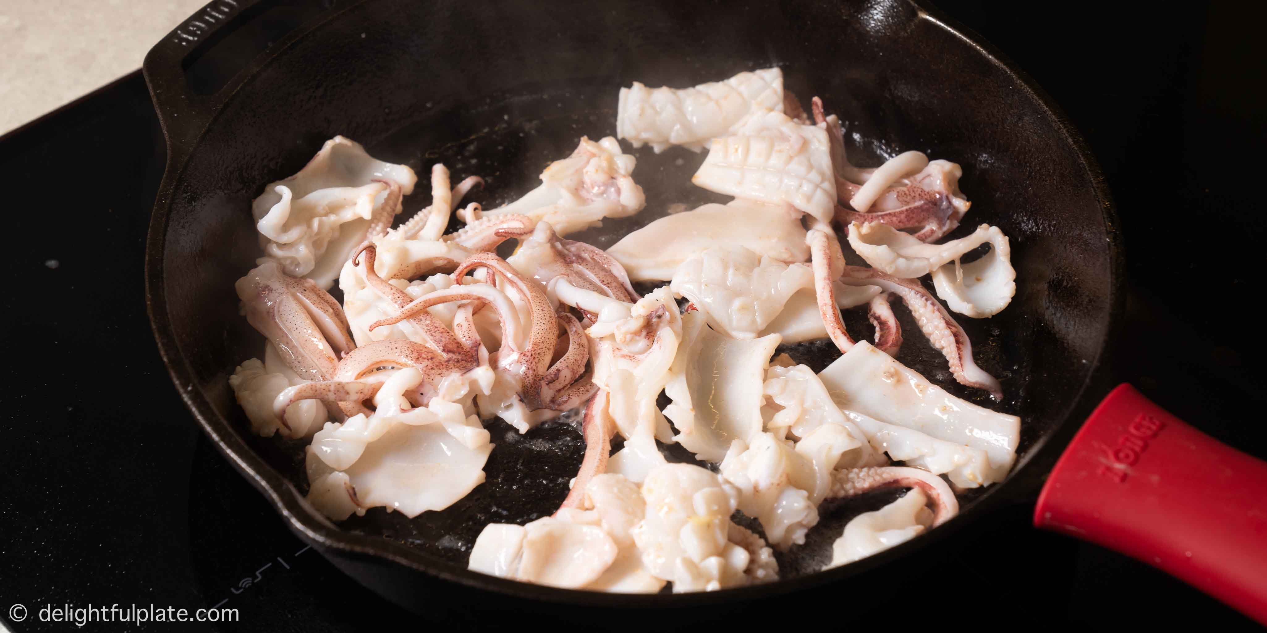 sautéing squid in a cast iron skillet