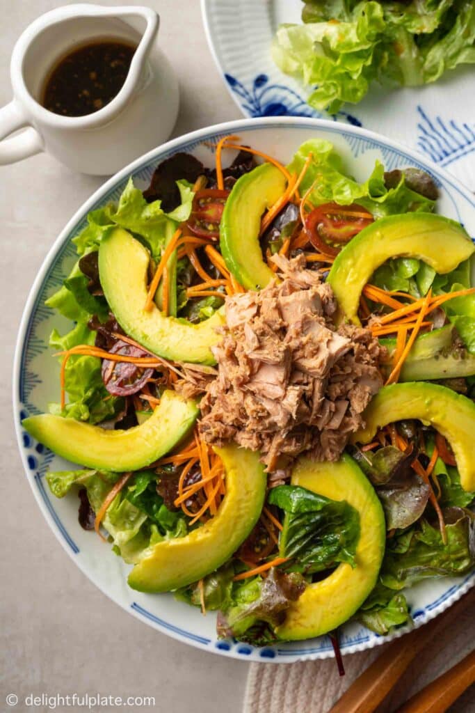 a plate of avocado tuna salad with soy sauce dressing