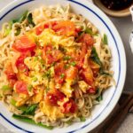a plate of noodles with scrambled eggs