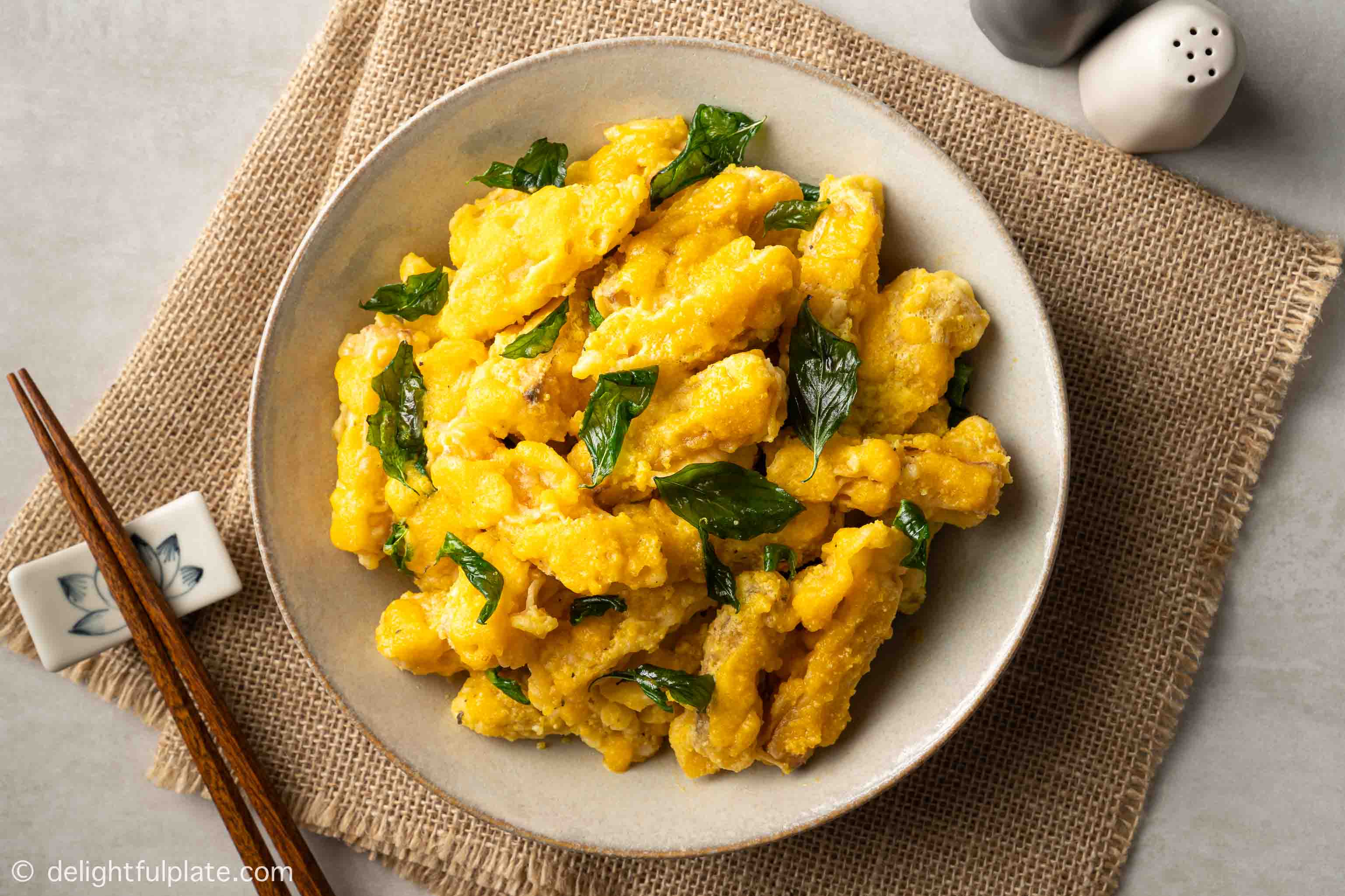 a plate of pumpkin fritters with salted egg sauce