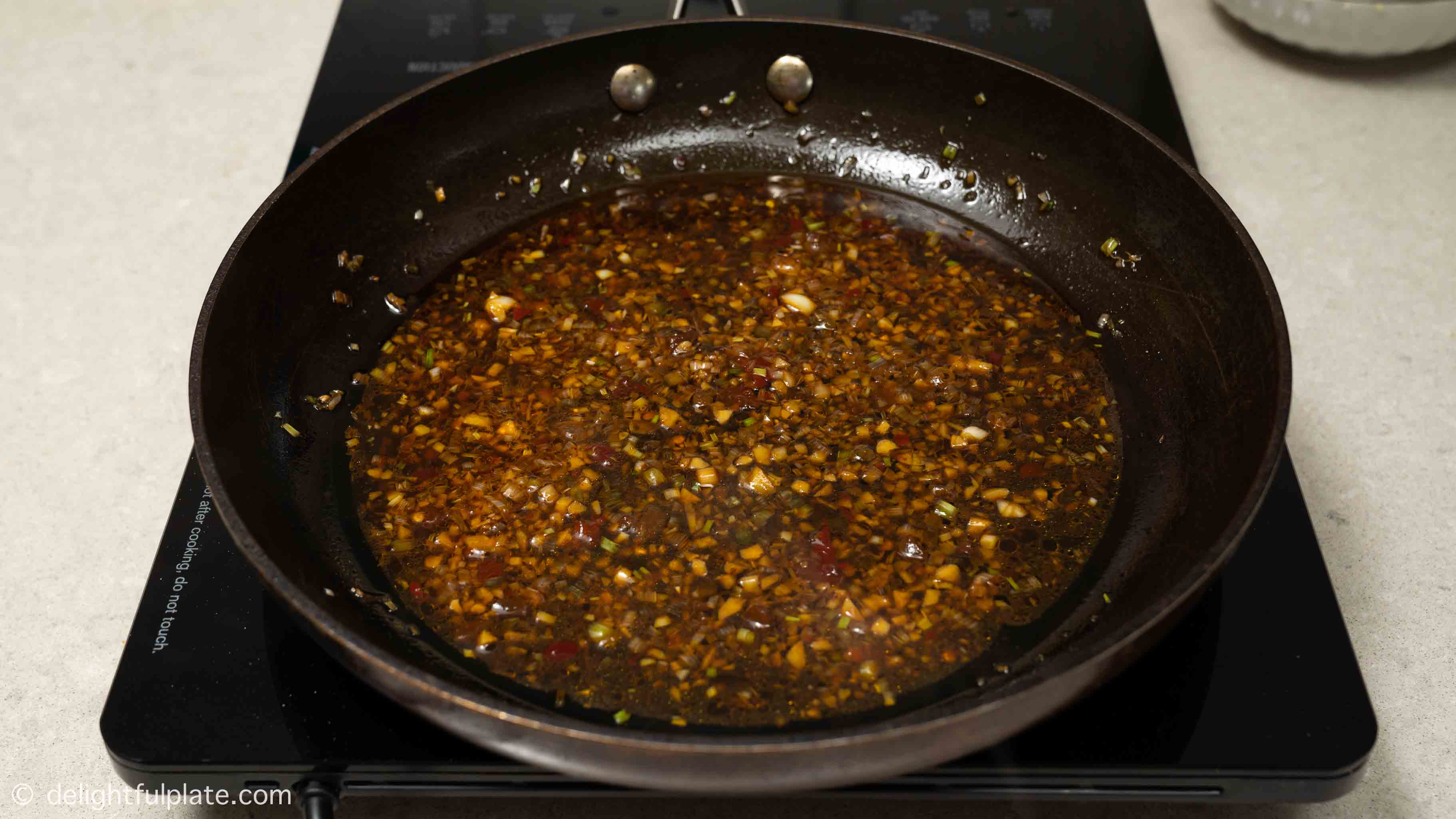 adding seasonings to the pan