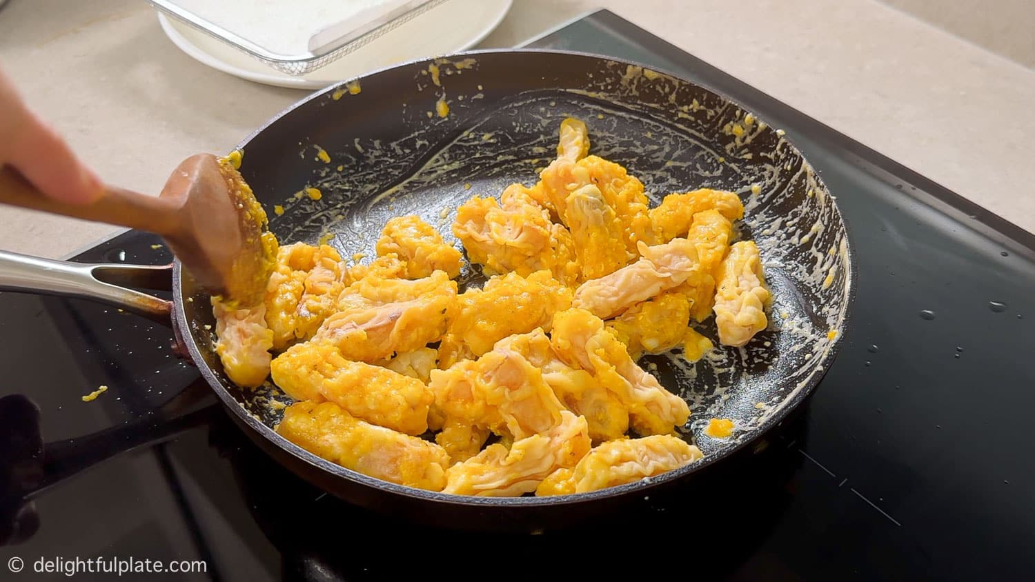 Tossing pumpkin with salted egg sauce