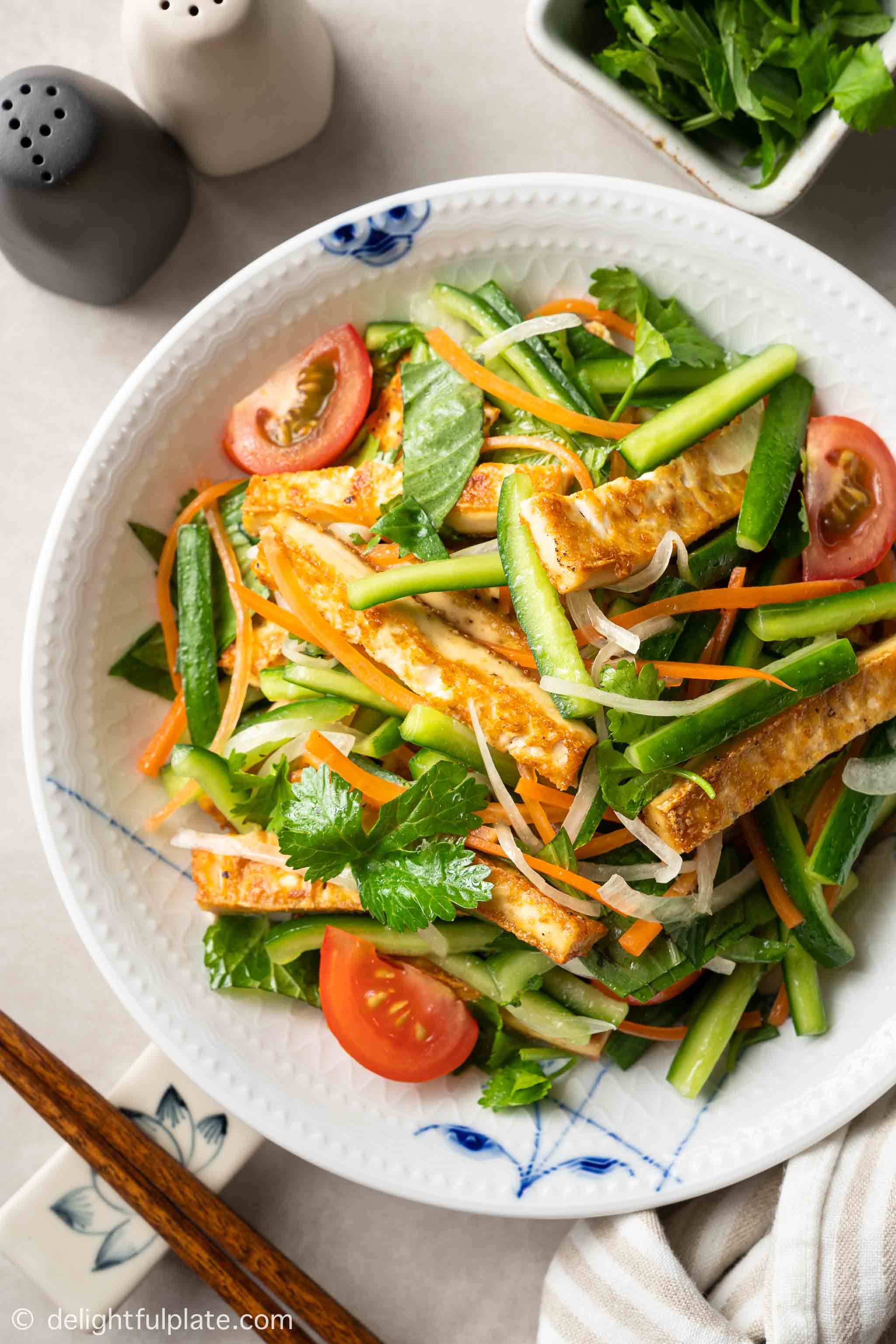 a plate of cucumber tofu salad
